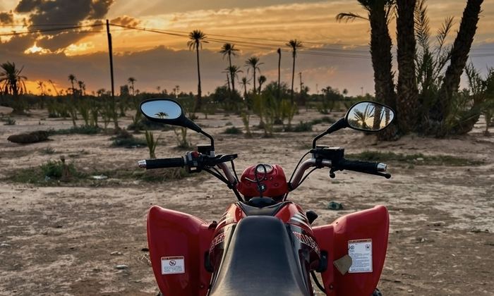 Red quad bike at sunset in the Marrakech palm grove